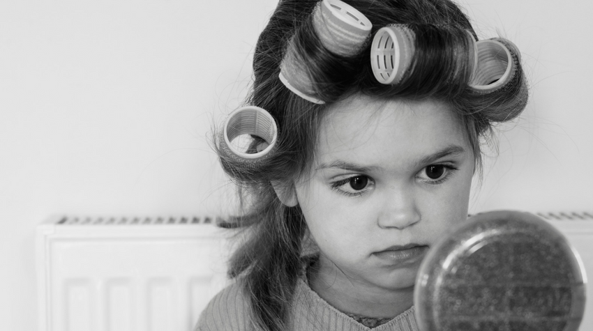 Canva stock photo little girl in curlers. POST:  RULES TO BREAK AFTER 50, WWW.SHARINGAJOURNEY.COM