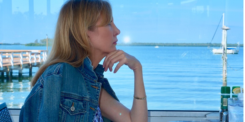 Nina from Sharing A Journey looking over the water six ways we sabotage our inner peace