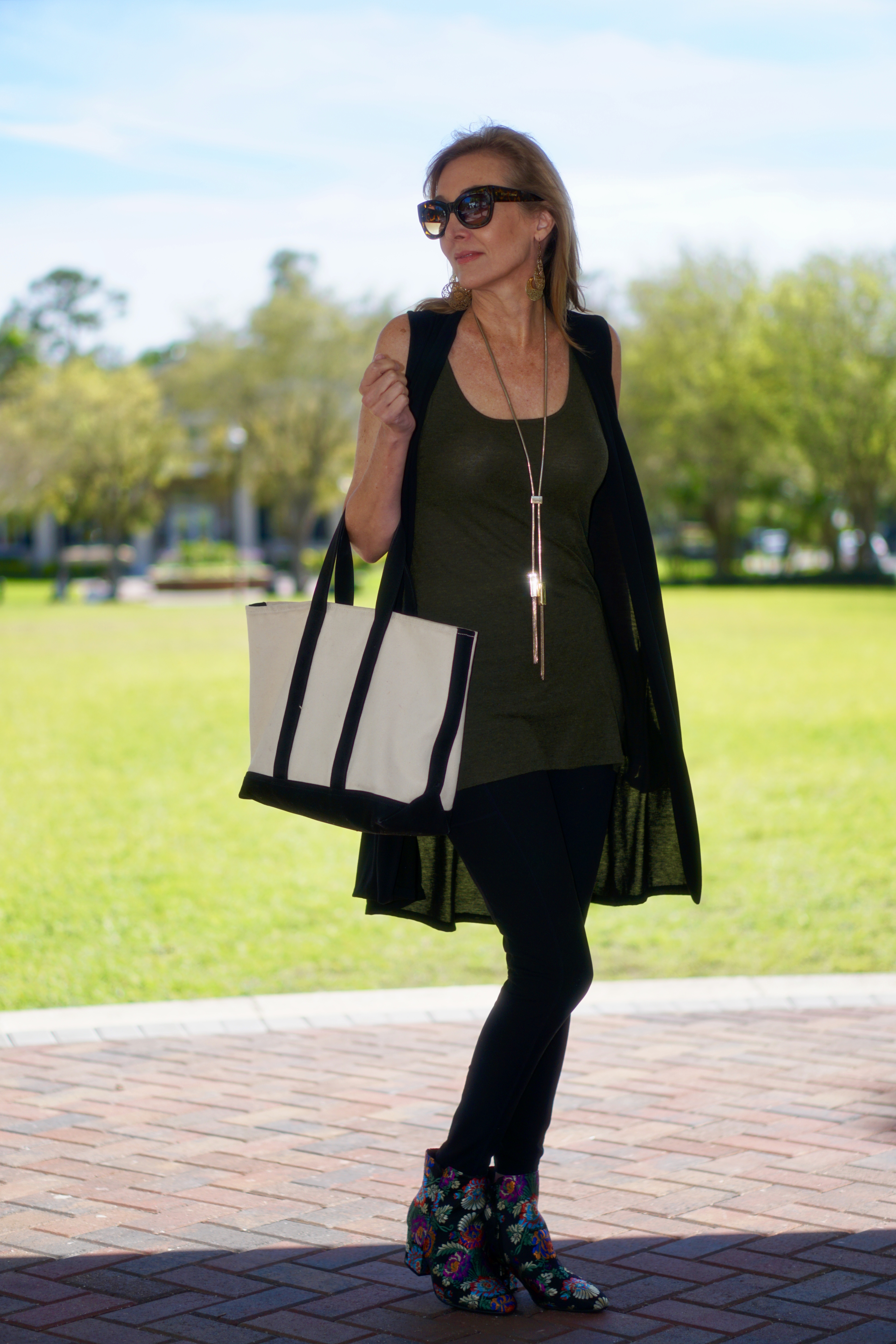 How to Wear Workout Clothes in Public, styling tips featured by top Tampo over 50 fashion blog, Sharing A Journey: Nina from sharingajourney wearing a black duster and leggings