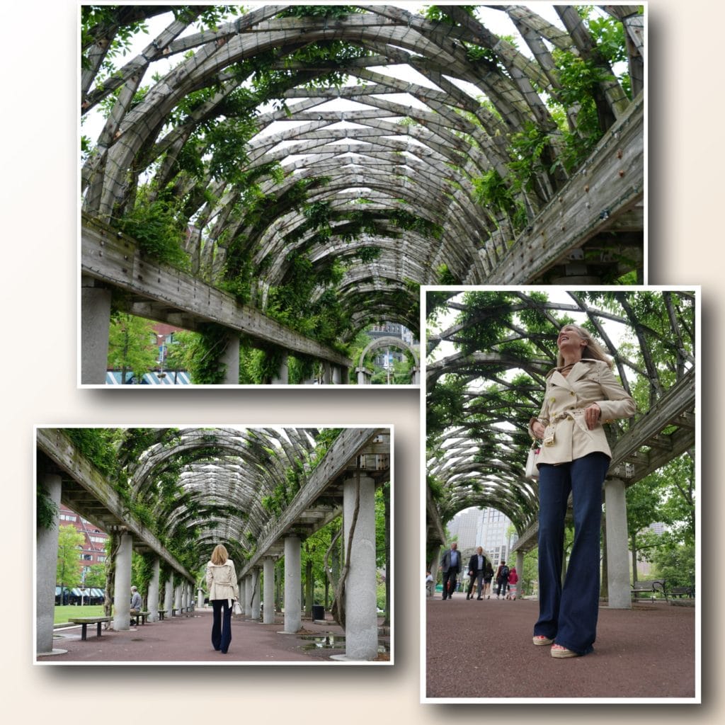 Woman exploring archways covered in greenery