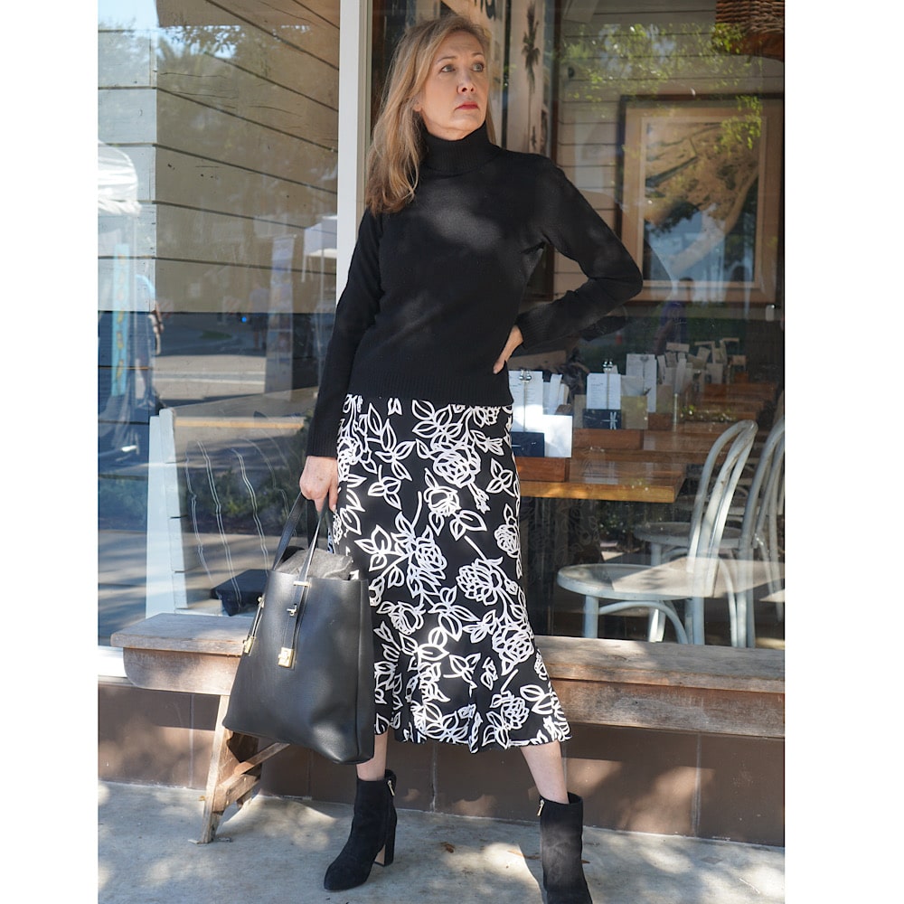 Nina from Sharing A Journey Style black skirt with booties how to style booties with skirts women over 50