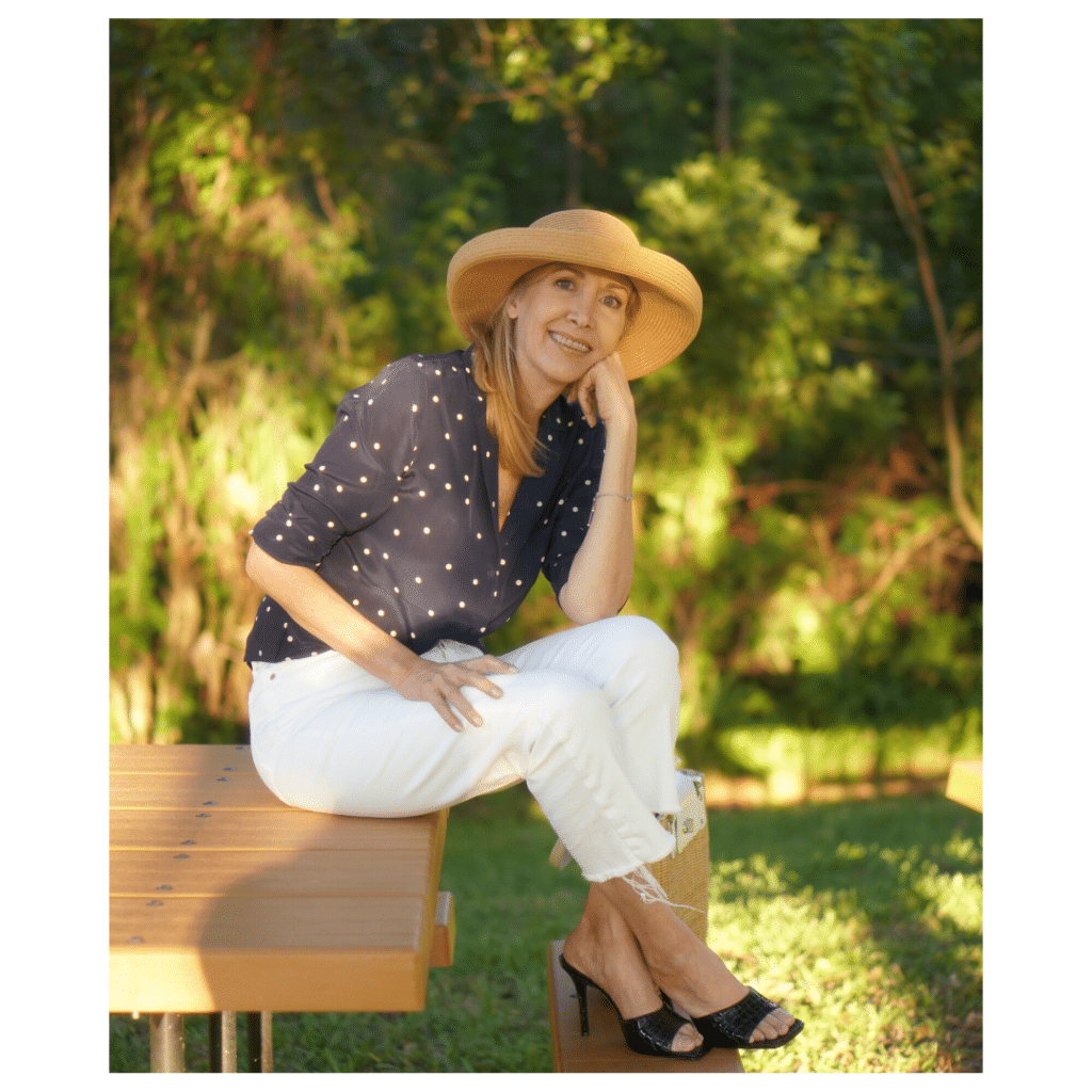Nina from Sharing A Journey styles white denim pants with a navy silk blouse for spring and summer.  Beautiful women over 50