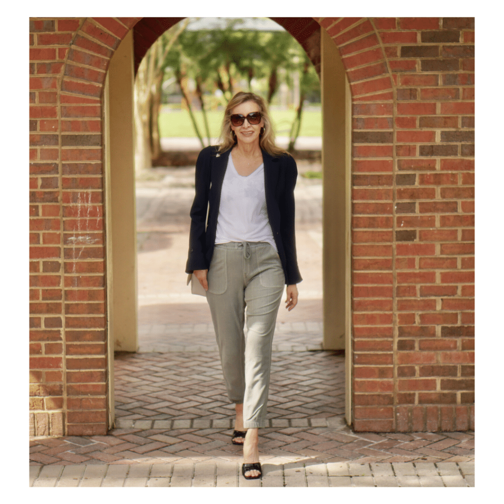 Nina from Sharing A Journey is wearing a blazer with joggers for a comfortable road trip outfit