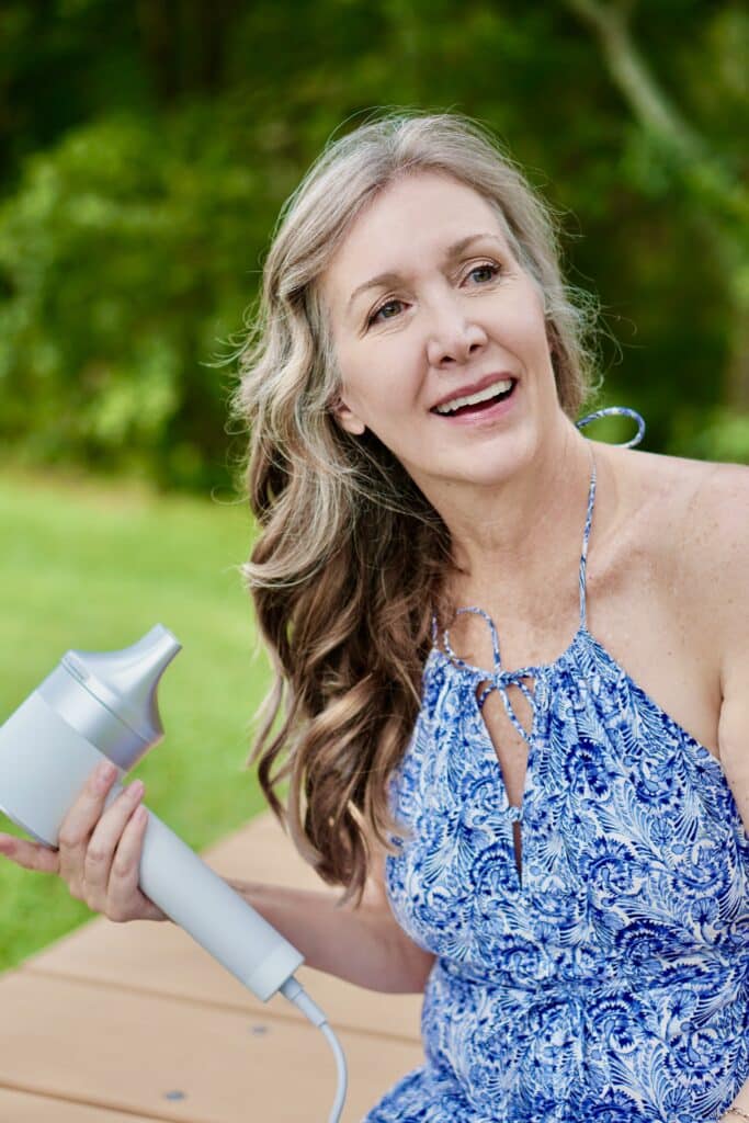 Nina Anders, over 50 influencer, styles hair with Zuvi Halo Hair Dryer