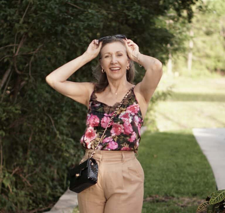 Nina Anders wearing floral camisole and tan trousers
